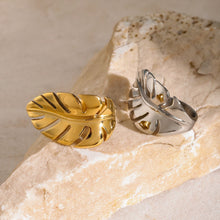 Load image into Gallery viewer, Make a bold statement with this leaf ring, a stylish and creative accessory designed for the modern woman. Made from rust-proof stainless steel, this elegant ring features a delicate leaf motif that exudes natural charm. Available in both silver and gold finishes, it offers versatility to match any outfit. Its sleek, waterproof design ensures long-lasting wear, making it the perfect accessory for any occasion.