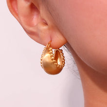 Load image into Gallery viewer, These trendy hoop earrings feature a charming basket boat shape with a unique edge design accented by small, delicate ball details. Crafted from durable stainless steel, they bring a playful yet sophisticated touch to any outfit, making them perfect for adding interest to everyday looks.
