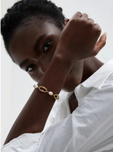 Load image into Gallery viewer, This elegant bracelet combines high-grade natural freshwater pearls with a modern, 18K gold plated metal chain for a trendy, stylish look. Featuring two contrasting chains and a toggle clasp, it strikes a beautiful balance between classic sophistication and contemporary flair. This eye-catching piece makes a perfect gift and elevates any outfit, whether for everyday wear or special occasions.