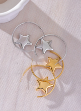 Load image into Gallery viewer, Enhance your style with these trendy stainless steel round star huggie earrings, available in sleek silver and radiant gold. Designed for modern women, their minimalist star charm adds a touch of elegance to any look. Crafted from anti-allergic stainless steel, they ensure comfort and durability, making them perfect for everyday wear. Whether as a thoughtful gift or a chic addition to your jewelry collection, these versatile earrings blend fashion and sophistication effortlessly.