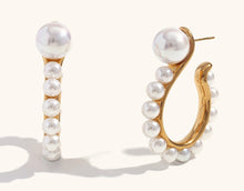 Load image into Gallery viewer, Make a bold statement with these exaggerated pearl hook earrings in a unique question mark shape. Crafted from durable stainless steel, these earrings are waterproof and hypoallergenic, ensuring comfort and long-lasting shine. The elegant pearl detail adds a touch of sophistication, making them perfect for both casual and formal occasions. A stylish and thoughtful gift for any jewelry lover!
