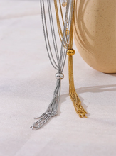 Load image into Gallery viewer, Elevate your style with this popular stainless steel long tassel necklace, featuring an 18K PVD gold plating for a luxurious finish. Its sleek, sweater chain design adds a trendy yet timeless touch to any outfit, making it perfect for layering or wearing alone. Durable and stylish, this personalized fashion piece is ideal for everyday wear or as a thoughtful gift for someone special.