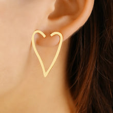 Load image into Gallery viewer, Make a bold statement with these exaggerated heart contour stainless steel stud earrings. Featuring a striking heart-shaped design, these earrings combine modern fashion with timeless elegance. Lightweight and durable, they’re perfect for adding a touch of flair to any outfit. A must-have accessory for women who love unique and stylish jewelry, these earrings are ideal for both everyday wear and special occasions.