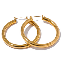 Load image into Gallery viewer, Elevate your style with these minimalistic big hollow hoop earrings, crafted from anti-allergic 316L stainless steel for lasting comfort and durability. Their sleek, round design offers a modern and trendy touch, perfect for adding effortless elegance to any outfit. Lightweight and versatile, these simple yet bold earrings are a must-have accessory for everyday wear or special occasions.