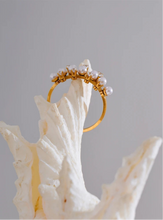 Load image into Gallery viewer, Enhance your elegance with this delicate adjustable golden ring, featuring luminous imitation pearls and sparkling zirconia accents. Crafted from durable stainless steel, this stylish ring offers a timeless design perfect for daily wear or special occasions. Its adjustable fit ensures comfort, making it a versatile and thoughtful gift for any woman who loves refined, feminine jewelry.