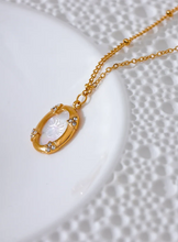 Load image into Gallery viewer, Add a touch of elegance to your look with this chic luxury round pendant necklace. Featuring a natural shell accented with a sparkling zircons and carved bee, this graceful design exudes French-inspired charm. Crafted from durable stainless steel, it’s waterproof and perfect for everyday wear or special occasions. A sophisticated accessory that blends style and durability, making it a timeless addition to any jewelry collection.