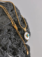 Load image into Gallery viewer, Add a touch of French elegance to your look with this stainless steel natural freshwater pearl necklace, featuring a delicate charm adorned with a turquoise stone at its center. Crafted with premium materials, this stylish piece is both waterproof and hypoallergenic, making it perfect for everyday wear without compromising on luxury. The natural freshwater pearl bring timeless beauty, while the turquoise stone adds a pop of color and a unique flair.