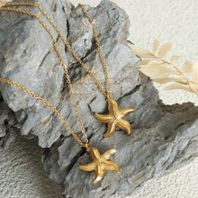 Load image into Gallery viewer, Make a bold statement with this edgy stainless steel star pendant necklace, designed for the modern woman with a punk-inspired aesthetic. Gold-plated for a sleek and stylish finish, this necklace exudes confidence and individuality. The striking star pendant adds a touch of celestial charm, making it the perfect accessory to elevate any look. Whether you're dressing up for a night out or adding a rebellious flair to your everyday style, this necklace is a versatile and eye-catching piece.