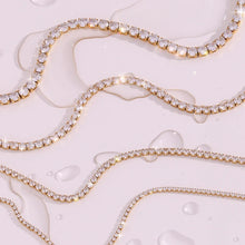 Load image into Gallery viewer, Elevate your style with this luxurious gold plated tennis necklace, featuring dazzling AAA-grade zircon stones for a radiant sparkle. Crafted from durable stainless steel, this trendy necklace combines elegance and durability, making it perfect for everyday wear or special occasions. A timeless accessory that adds a touch of sophistication to any outfit, it’s a must-have for any jewelry collection or a thoughtful gift for someone special.