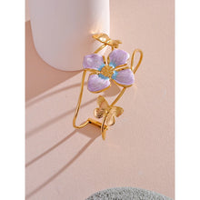 Load image into Gallery viewer, Make a bold statement with our gold-plated stainless steel enamel open bangle, designed for fashionable women who love eye-catching accessories. This stylish bangle features an exaggerated, large design adorned with a delicate butterfly and a vibrant purple flower, adding a whimsical and feminine touch to any outfit. Perfect for making a statement at any occasion, this chic and modern bracelet is a must-have for those who want to stand out with elegance and creativity.