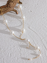 Load image into Gallery viewer, This elegant necklace features a delicate stainless steel chain adorned with imitation pearl beads, spaced gracefully along its length for a refined, charming look. The short, lightweight design is enhanced by a hanging chain detail, adding a touch of sophistication that’s perfect for galas, evening events, or daily wear.