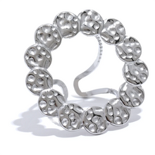 Load image into Gallery viewer, This bold stainless steel ring features a large, open round design crafted from interlocking hammered circles, creating a unique and eye-catching look. Its hollow, hyperbolic shape gives it a personalized, vintage-inspired appeal, perfect for adding a stylish, edgy touch to any outfit. With its trendy, textured metal and artistic detail, this ring is a standout piece for those who love statement jewelry that exudes individuality and modern charm.