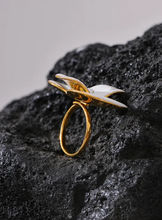 Load image into Gallery viewer, This exquisite adjustable ring showcases a delicate white enamel flower, set on durable, waterproof stainless steel for a chic yet enduring design. With its elegant floral detailing, this ring adds a refined, feminine touch to any outfit, embodying a timeless yet fashion-forward aesthetic. Perfect for daily wear or special occasions, it’s a versatile piece that complements any style.
