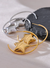 Load image into Gallery viewer, Enhance your style with these trendy stainless steel round star huggie earrings, available in sleek silver and radiant gold. Designed for modern women, their minimalist star charm adds a touch of elegance to any look. Crafted from anti-allergic stainless steel, they ensure comfort and durability, making them perfect for everyday wear. Whether as a thoughtful gift or a chic addition to your jewelry collection, these versatile earrings blend fashion and sophistication effortlessly.