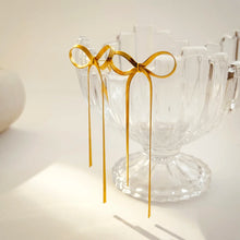 Load image into Gallery viewer, These long tassel bow earrings are a striking statement piece, featuring a graceful bowknot design with sleek flat snake chains that add a sense of fluid movement. Made from high-quality stainless steel, they are both durable and lightweight, offering a stylishly modern look with a hint of elegance.