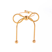 Load image into Gallery viewer, This elegant open slim ring features a charming bow design with delicate tassel accents, crafted from durable stainless steel and plated in radiant 18K gold. Waterproof and stylish, it’s perfect for daily wear or special occasions, offering a blend of sophistication and modern flair. A versatile accessory for women and girls, this new arrival adds a graceful touch to any jewelry collection.