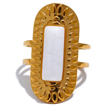 Load image into Gallery viewer, Make a statement with this striking square geometric open ring, featuring a bold, big stone available in four captivating colors: black, red, white, and green. Each stone is beautifully framed by a notched gold edge, adding texture and a luxurious touch to this modern design. Crafted from durable stainless steel and finished with high-quality gold plating, this wide, adjustable ring combines elegance with a contemporary twist, offering a perfect fit and lasting shine.