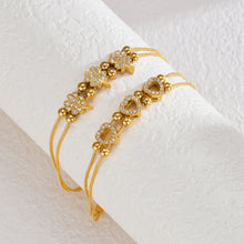 Load image into Gallery viewer, Add a touch of elegance to your look with this luxurious bracelet, featuring a heart shaped pendants inlaid with shimmering zircons. Crafted from gold-plated stainless steel, it offers both durability and timeless charm. Perfect for weddings, special occasions, or everyday sophistication, this exquisite piece makes a thoughtful and stylish gift for any woman.