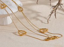 Load image into Gallery viewer, Add a touch of romance to your look with this stunning 85cm stainless steel heart contour charm necklace, available in both silver and gold finishes. Elegantly designed, this long chest chain features delicate heart-shaped charms spread along the length of the chain, creating a subtle yet captivating statement of love. Crafted from durable, waterproof stainless steel, this piece ensures lasting shine and beauty, making it perfect for both everyday wear and special occasions.