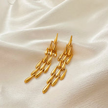 Load image into Gallery viewer, These creative teardrop earrings feature an intricate mesh design, plated in gold for a luxurious yet lightweight look. Crafted from high-quality stainless steel, they include delicate long tassels that add movement and elegance, making them a standout accessory for any occasion. Perfect for those who love stylish, eye-catching jewelry, these earrings offer a chic blend of modern flair and timeless charm, ideal for effortlessly enhancing any outfit.