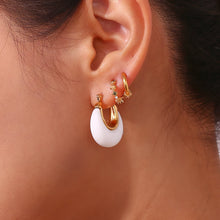 Load image into Gallery viewer, Elevate your everyday style with these chic acrylic white hoop earrings, featuring a delicate gold inner line for a touch of luxe. The small, round design paired with a sturdy stainless steel hoop makes them both stylish and durable. Whether you're dressing up or down, these versatile earrings add a perfect pop of modern elegance to any outfit.
