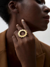 Load image into Gallery viewer, This bold stainless steel ring features a large, open round design crafted from interlocking hammered circles, creating a unique and eye-catching look. Its hollow, hyperbolic shape gives it a personalized, vintage-inspired appeal, perfect for adding a stylish, edgy touch to any outfit. With its trendy, textured metal and artistic detail, this ring is a standout piece for those who love statement jewelry that exudes individuality and modern charm.