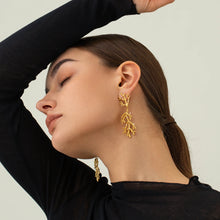 Load image into Gallery viewer, These trendy drop earrings feature a unique coral-textured design, plated in radiant 18K gold and adorned with delicate inlaid pearls for a touch of elegance. Crafted from high-quality stainless steel, they combine durability with sophistication, making them perfect for women who love standout accessories. Ideal as a thoughtful gift, these earrings add a luxurious and modern flair to any outfit.
