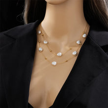 Load image into Gallery viewer, This elegant double-layer necklace combines the timeless beauty of a delicate thin stainless steel chain with the classic allure of freshwater pearls, creating a refined accessory perfect for any occasion. Its layered design adds depth and sophistication, making it an ideal choice for parties or stylish everyday wear. Crafted to last, this necklace is both chic and versatile, offering a graceful touch to any outfit and a lovely addition to any jewelry collection.