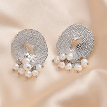 Load image into Gallery viewer, Add a touch of romance to your look with these exquisite French-inspired earrings. Featuring irregular hammered stainless steel circles with elegant hanging pearls, they blend vintage charm with modern sophistication. Perfect for weddings, anniversaries, or special occasions, these earrings make a timeless statement and a thoughtful gift for someone special.