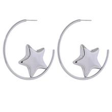 Load image into Gallery viewer, Enhance your style with these trendy stainless steel round star huggie earrings, available in sleek silver and radiant gold. Designed for modern women, their minimalist star charm adds a touch of elegance to any look. Crafted from anti-allergic stainless steel, they ensure comfort and durability, making them perfect for everyday wear. Whether as a thoughtful gift or a chic addition to your jewelry collection, these versatile earrings blend fashion and sophistication effortlessly.