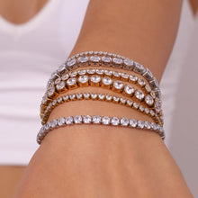 Load image into Gallery viewer, Elevate your style with this luxurious gold plated tennis bracelet, featuring dazzling AAA-grade zircon stones for a radiant sparkle. Crafted from durable stainless steel, this trendy bracelet combines elegance and durability, making it perfect for everyday wear or special occasions. A timeless accessory that adds a touch of sophistication to any outfit, it’s a must-have for any jewelry collection or a thoughtful gift for someone special.