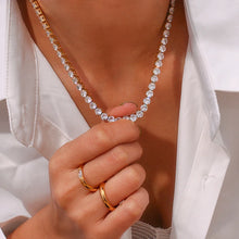 Load image into Gallery viewer, Elevate your style with this luxurious gold plated tennis necklace, featuring dazzling AAA-grade zircon stones for a radiant sparkle. Crafted from durable stainless steel, this trendy necklace combines elegance and durability, making it perfect for everyday wear or special occasions. A timeless accessory that adds a touch of sophistication to any outfit, it’s a must-have for any jewelry collection or a thoughtful gift for someone special.