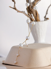 Load image into Gallery viewer, This elegant necklace features a delicate stainless steel chain adorned with imitation pearl beads, spaced gracefully along its length for a refined, charming look. The short, lightweight design is enhanced by a hanging chain detail, adding a touch of sophistication that’s perfect for galas, evening events, or daily wear.