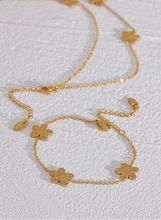 Load image into Gallery viewer, This delicate and classy bracelet is made out of stainless steel with 18K gold plating. It consists of a thin chain with three flower charms and it comes in gold colour. It has a size adjustable lobster clasp. It can be worn as a perfect summer accessory.