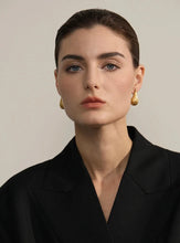 Load image into Gallery viewer, Add a touch of elegance to your look with these fashion stainless steel teardrop stud earrings. Featuring a sleek water drop design and a modern metal texture, these earrings are both trendy and timeless. Made from anti-allergic stainless steel, they offer comfort and durability, perfect for sensitive ears. Whether for everyday wear or a special occasion, these versatile earrings make a stylish addition to any jewelry collection and a thoughtful gift for someone special.