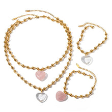 Load image into Gallery viewer, This elegant stainless steel necklace comes in two options, with pink or clear heart pendant. The necklace has a very interesting chain adorned with small stainless steel balls. The heart pendant is made of glass and it makes this necklace a perfect piece for an elegant occasion outfit. The necklace has a lobster clasp and adjustable length.