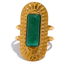 Load image into Gallery viewer, Make a statement with this striking square geometric open ring, featuring a bold, big stone available in four captivating colors: black, red, white, and green. Each stone is beautifully framed by a notched gold edge, adding texture and a luxurious touch to this modern design. Crafted from durable stainless steel and finished with high-quality gold plating, this wide, adjustable ring combines elegance with a contemporary twist, offering a perfect fit and lasting shine.
