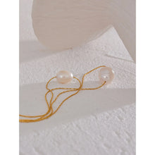 Load image into Gallery viewer, This glamorous stainless steel necklace features an elegant double chain design, each strand adorned with a single, lustrous natural freshwater pearl. The larger pearls add a touch of sophistication and elevate the necklace's overall style, making it a striking accessory. Perfect for complementing an evening outfit or adding a touch of elegance to your daily look, this versatile piece is both stylish and refined. The necklace is finished with a secure lobster clasp and an adjustable chain.