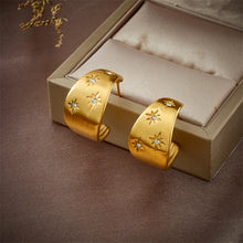 Load image into Gallery viewer, These unique earrings showcase an artistic blend of bohemian charm with a playful design, featuring a banana-shaped water drop element and diagonal circular accents, adorned with shimmering zircons. The intricate long eyelash details add texture and flair, making these earrings a true statement piece. Perfect for adding a touch of creativity and sparkle to any look, these earrings are ideal for those who love bold, eye-catching jewelry.