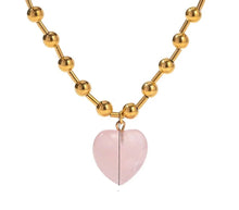 Load image into Gallery viewer, This elegant stainless steel necklace comes in two options, with pink or clear heart pendant. The necklace has a very interesting chain adorned with small stainless steel balls. The heart pendant is made of glass and it makes this necklace a perfect piece for an elegant occasion outfit. The necklace has a lobster clasp and adjustable length.
