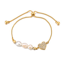 Load image into Gallery viewer, Add a touch of elegance to your look with this stainless steel heart charm bracelet. Adorned with natural pearls and a sparkling zircon heart pendant, and finished with 18K gold plating, this bracelet exudes timeless sophistication. Perfect for women who love graceful and versatile accessories, it’s a stunning piece for both everyday wear and special occasions. A thoughtful gift or a chic addition to any jewelry collection.