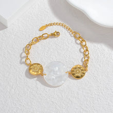 Load image into Gallery viewer, Embrace effortless elegance with this stylish bracelet, featuring a radiant sun pendant paired with a shell disc in your choice of white or black. Crafted from 18K gold-plated stainless steel, this waterproof piece is both durable and chic, making it perfect for daily wear or special occasions. A timeless accessory and a thoughtful gift for any jewelry lover.