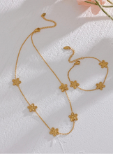 Load image into Gallery viewer, This delicate and classy bracelet is made out of stainless steel with 18K gold plating. It consists of a thin chain with three flower charms and it comes in gold colour. It has a size adjustable lobster clasp. It can be worn as a perfect summer accessory.