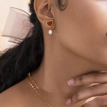 Load image into Gallery viewer, Embrace timeless romance with these stainless steel inlaid onyx heart shape freshwater pearl earrings. Featuring a stunning combination of glossy onyx hearts and delicate freshwater pearls, these earrings exude elegance and charm. Crafted from durable stainless steel, they offer a sophisticated, tarnish-resistant finish, making them perfect for any occasion. A thoughtful and stylish gift for someone special or a beautiful addition to your jewelry collection.
