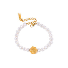 Load image into Gallery viewer, This elegant, vintage-inspired bracelet is crafted from lustrous pearls and features a striking gold-tone hammered stainless steel ball, adding a touch of timeless sophistication. The intricate detailing of the embossed ball beautifully complements the classic pearl design, making this bracelet the perfect accessory for any glamorous or elegant outfit. Finished with a secure lobster clasp and an adjustable chain, it ensures a comfortable and customizable fit.