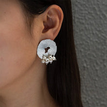 Load image into Gallery viewer, Add a touch of romance to your look with these exquisite French-inspired earrings. Featuring irregular hammered stainless steel circles with elegant hanging pearls, they blend vintage charm with modern sophistication. Perfect for weddings, anniversaries, or special occasions, these earrings make a timeless statement and a thoughtful gift for someone special.