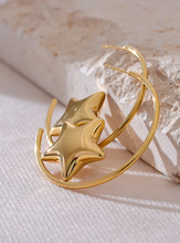 Load image into Gallery viewer, Enhance your style with these trendy stainless steel round star huggie earrings, available in sleek silver and radiant gold. Designed for modern women, their minimalist star charm adds a touch of elegance to any look. Crafted from anti-allergic stainless steel, they ensure comfort and durability, making them perfect for everyday wear. Whether as a thoughtful gift or a chic addition to your jewelry collection, these versatile earrings blend fashion and sophistication effortlessly.