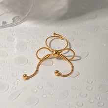 Load image into Gallery viewer, This elegant open slim ring features a charming bow design with delicate tassel accents, crafted from durable stainless steel and plated in radiant 18K gold. Waterproof and stylish, it’s perfect for daily wear or special occasions, offering a blend of sophistication and modern flair. A versatile accessory for women and girls, this new arrival adds a graceful touch to any jewelry collection.