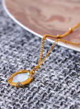 Load image into Gallery viewer, Add a touch of elegance to your look with this chic luxury round pendant necklace. Featuring a natural shell accented with a sparkling zircons and carved bee, this graceful design exudes French-inspired charm. Crafted from durable stainless steel, it’s waterproof and perfect for everyday wear or special occasions. A sophisticated accessory that blends style and durability, making it a timeless addition to any jewelry collection.