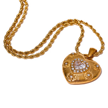 Load image into Gallery viewer, Show your love with this exquisite stainless steel heart love cubic zirconia pendant necklace. Featuring a dazzling heart-shaped cubic zirconia pendant in radiant gold color, this necklace exudes romance and sophistication. Crafted from high-quality stainless steel, it offers lasting shine and durability, making it perfect for everyday wear or special occasions. A timeless piece of jewelry that makes a thoughtful gift or a beautiful addition to your collection.